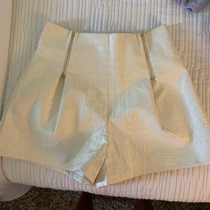 Snakeskin printed shorts with gold zippers in front & zipper on the side